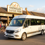 Knowsley Safari Day Trip from Liverpool by Minibus 4 Minibus parked at Knowsley Safari Park entrance near Liverpool for group day trip